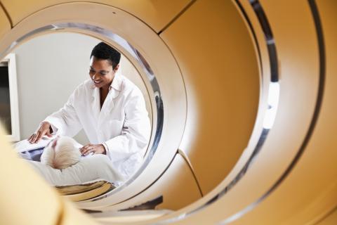 Radiologist preparing patient for pet ct scanner